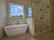 Modern bathroom featuring a standalone tub and a separate glass-enclosed shower at 6490 Mockingbird Rd, Cumming, GA 30028