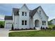 Charming home featuring white siding, attached garage, and a well-maintained lawn at 6490 Mockingbird Rd, Cumming, GA 30028