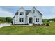 Beautiful two-story home showcasing white siding, dark roof, and manicured lawn at 6490 Mockingbird Rd, Cumming, GA 30028