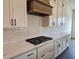 Close-up of the kitchen with white cabinets, subway tile backsplash, and modern appliances at 6490 Mockingbird Rd, Cumming, GA 30028