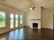 Bright living room featuring a cozy fireplace, high ceilings, and natural light at 6490 Mockingbird Rd, Cumming, GA 30028