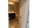 Cozy half bathroom features neutral stone tiling, white door, and classic fixtures at 1280 W Peachtree Nw St # 2801, Atlanta, GA 30309