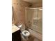 Charming bathroom with a shower-tub combo, neutral tiling, and dark wood vanity at 1280 W Peachtree Nw St # 2801, Atlanta, GA 30309