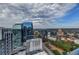 Breathtaking cityscape view of modern buildings and lush greenery under a partly cloudy sky at 1280 W Peachtree Nw St # 2801, Atlanta, GA 30309