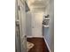 Well-lit hallway features hardwood floors, floating shelving, and white paneled doors, creating a cozy entrance at 1280 W Peachtree Nw St # 2801, Atlanta, GA 30309