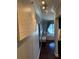 Bright hallway with hardwood floors, overhead track lighting, a decorative canvas, and glimpses of the living room at 1280 W Peachtree Nw St # 2801, Atlanta, GA 30309