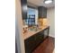 Functional kitchen with dark cabinets, stainless steel appliances, a view to the dining area, and durable countertops at 1280 W Peachtree Nw St # 2801, Atlanta, GA 30309