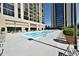 Outdoor pool surrounded by lounge chairs and lush landscaping with building views at 1280 W Peachtree Nw St # 2801, Atlanta, GA 30309