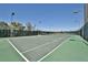 Well-lit outdoor tennis court with a green surface, set against a backdrop of trees at 1280 W Peachtree Nw St # 2801, Atlanta, GA 30309