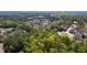 Scenic aerial view showcases community near a wooded area and Downtown Woodstock at 130 Inwood Walk, Woodstock, GA 30188
