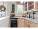 Charming bar area with granite counters, wood cabinets, wine cooler, and eat drink and give thanks signage at 130 Inwood Walk, Woodstock, GA 30188