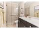 Modern bathroom featuring a glass-enclosed shower, vanity with sink, and tile walls at 130 Inwood Walk, Woodstock, GA 30188