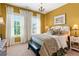 Inviting bedroom featuring bright yellow walls, two windows, and a chandelier at 130 Inwood Walk, Woodstock, GA 30188