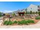 Inviting community entrance with stone signage, manicured landscaping, pergola, and seating area at 130 Inwood Walk, Woodstock, GA 30188