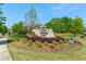 Community entrance sign with manicured landscaping, promoting a welcoming atmosphere at 130 Inwood Walk, Woodstock, GA 30188