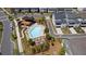 Aerial view of community pool and amenity center with sundeck, lounge chairs, and surrounding homes at 130 Inwood Walk, Woodstock, GA 30188