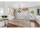 Dining room featuring a decorative chandelier, patterned rug, and a glass panel door leading to the exterior at 130 Inwood Walk, Woodstock, GA 30188
