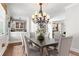 Formal dining room featuring a chandelier, a door to outside, and a view into another room at 130 Inwood Walk, Woodstock, GA 30188