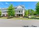 Exterior daytime view of townhomes with covered front porches and manicured lawns at 130 Inwood Walk, Woodstock, GA 30188