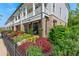 Townhome exterior with beautiful landscaping and a well-maintained facade at 130 Inwood Walk, Woodstock, GA 30188