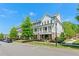 A row of townhomes with covered front porches, tidy landscaping, and sidewalks at 130 Inwood Walk, Woodstock, GA 30188
