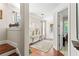 Bright foyer with hardwood floors, stylish console table, and an open doorway, creating a welcoming ambiance at 130 Inwood Walk, Woodstock, GA 30188