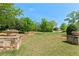 Inviting community greenspace flanked by stone columns and verdant landscaping at 130 Inwood Walk, Woodstock, GA 30188
