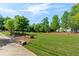Community green space with benches, lush trees, and well-maintained lawn at 130 Inwood Walk, Woodstock, GA 30188