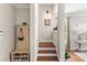 Hallway featuring staircase, coat rack, and console table, creating a functional transition between spaces at 130 Inwood Walk, Woodstock, GA 30188