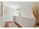 Upstairs hallway featuring hardwood floors, neutral walls, and a decorative vase at 130 Inwood Walk, Woodstock, GA 30188