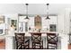 Modern kitchen featuring white cabinets, stainless steel appliances, and a spacious island with seating for three at 130 Inwood Walk, Woodstock, GA 30188