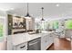 Open kitchen with a large island, stainless steel appliances, and seamless flow into the living area at 130 Inwood Walk, Woodstock, GA 30188
