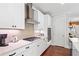 Well-equipped kitchen featuring stainless steel appliances, ample counter space, and modern white cabinetry at 130 Inwood Walk, Woodstock, GA 30188
