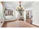 Spacious living room featuring hardwood floors, a large area rug, and an elegant chandelier at 130 Inwood Walk, Woodstock, GA 30188