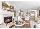 Inviting living room with fireplace, TV, comfortable seating and open layout to kitchen at 130 Inwood Walk, Woodstock, GA 30188