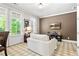Cozy living room with abundant natural light, comfortable seating, and tasteful decor, perfect for relaxation at 130 Inwood Walk, Woodstock, GA 30188