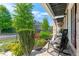 Relaxing front porch with rocking chairs, complemented by colorful landscaping and brick accents at 130 Inwood Walk, Woodstock, GA 30188