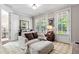 Cozy sitting room featuring a comfortable lounge chair, natural light and stylish decor accents at 130 Inwood Walk, Woodstock, GA 30188
