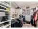 Well-organized walk-in closet with shelving and hanging space for clothes and accessories at 130 Inwood Walk, Woodstock, GA 30188