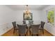 Bright dining space with hardwood floors, crown molding, and a clear view to the backyard at 2357 Burnt Creek Rd, Decatur, GA 30033