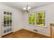 This dining area features hardwood floors, natural light, and access to the screened patio at 2357 Burnt Creek Rd, Decatur, GA 30033