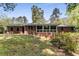 Traditional brick home featuring a sunroom and a well-manicured lawn at 2357 Burnt Creek Rd, Decatur, GA 30033