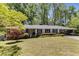 Charming single-story home with brick accents, covered parking, and mature trees at 2357 Burnt Creek Rd, Decatur, GA 30033