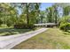 Charming one-story home with a long driveway and lush landscaping, perfect for suburban living at 2357 Burnt Creek Rd, Decatur, GA 30033