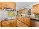 This kitchen offers wooden cabinetry, granite countertops, stainless steel appliances, and natural light at 2357 Burnt Creek Rd, Decatur, GA 30033