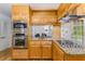 Cozy kitchen features wooden cabinets, stainless steel appliances, and a view to the living room at 2357 Burnt Creek Rd, Decatur, GA 30033