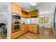Bright kitchen with wooden cabinetry, stainless steel appliances, and a view of the living room at 2357 Burnt Creek Rd, Decatur, GA 30033