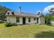 View of backyard with green grass, siding, and trees under a blue sky at 25 Bridlewood Ct, Stockbridge, GA 30281