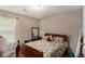 Comfortable bedroom with a window and a full-sized bed adorned with floral bedding at 25 Bridlewood Ct, Stockbridge, GA 30281