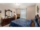 This bedroom offers a relaxing space with a large dresser and a comfortable bed with stylish blue bedding at 25 Bridlewood Ct, Stockbridge, GA 30281